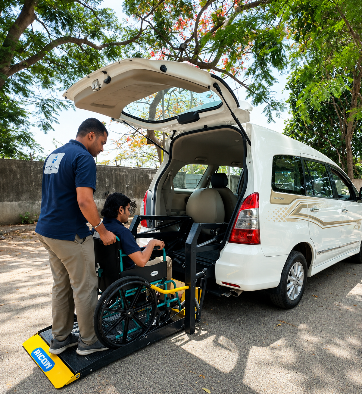 Wheelchair user boarding a modified white Toyota Innova using a rear access platform